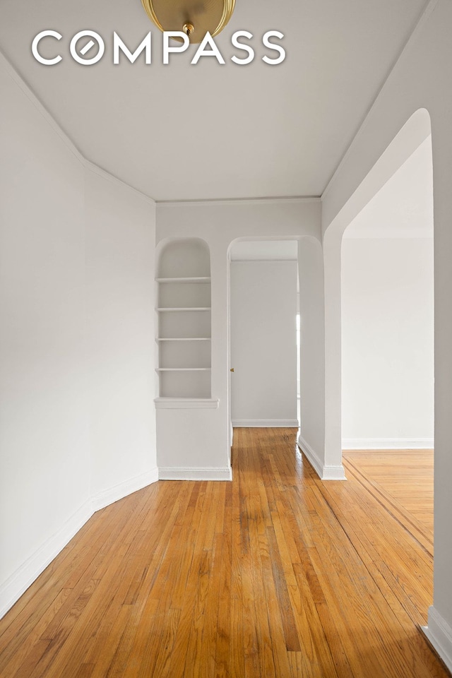 76-12 35th Ave Unit 6J, New York City, NY 11372 - empty room with hardwood / wood-style flooring and built in features