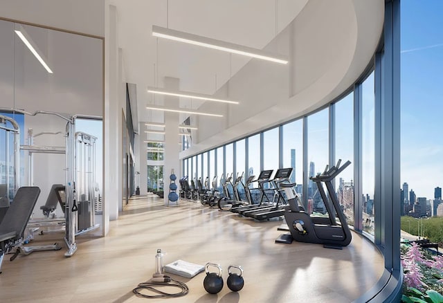 24-16 Queens Plz S Unit 3G, New York City, NY 11101 - workout area with a high ceiling, a wall of windows, a view of city, and wood finished floors