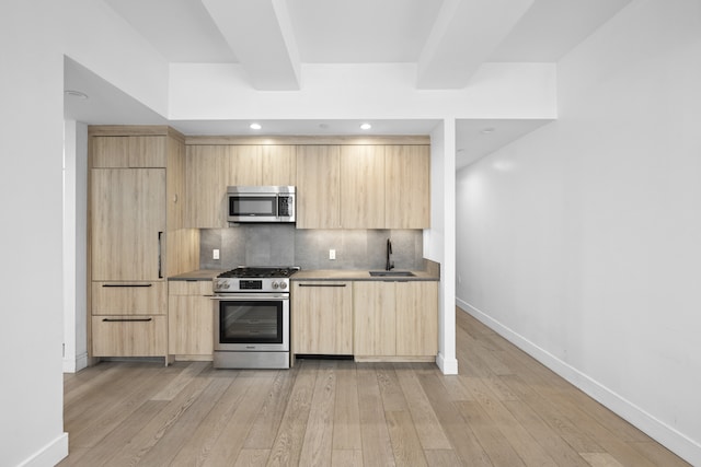 24-16 Queens Plz S Unit 3G, New York City, NY 11101 - kitchen with light brown cabinets, appliances with stainless steel finishes, modern cabinets, light wood-style floors, and tasteful backsplash