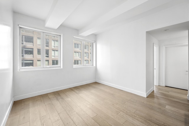 24-16 Queens Plz S Unit 3G, New York City, NY 11101 - empty room with light wood-style floors and beam ceiling