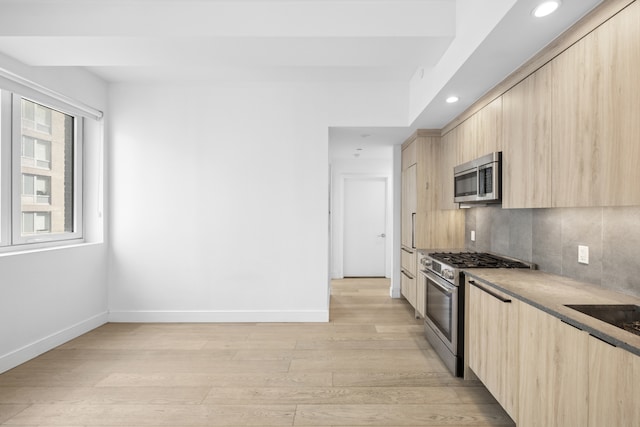 24-16 Queens Plz S Unit 3G, New York City, NY 11101 - kitchen featuring light brown cabinetry, appliances with stainless steel finishes, modern cabinets, light wood finished floors, and recessed lighting