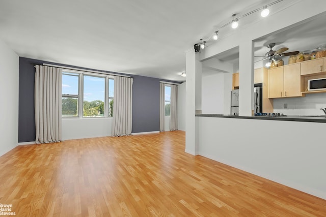 5425 Valles Ave Unit 5G, New York City, NY 10471 - unfurnished living room featuring healthy amount of natural light, light wood-type flooring, and a ceiling fan