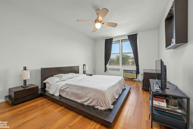5425 Valles Ave Unit 5G, New York City, NY 10471 - bedroom with wood-type flooring, radiator heating unit, and ceiling fan