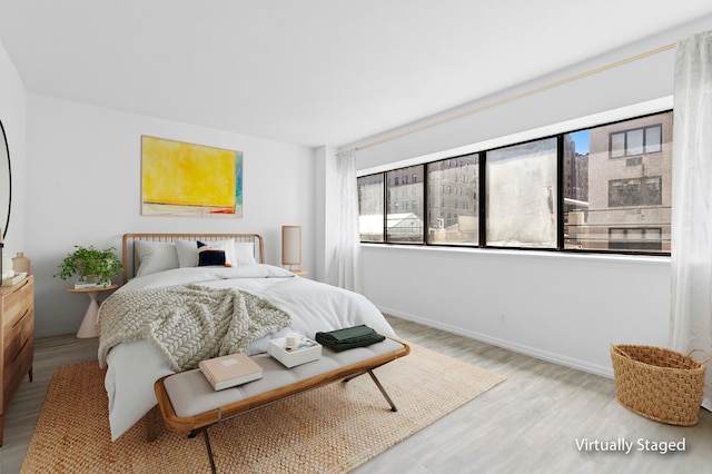32 E 76th St Unit 605, New York City, NY 10021 - bedroom featuring wood finished floors and baseboards