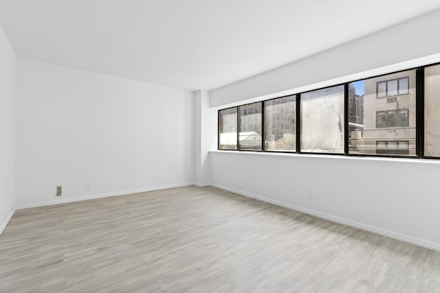 32 E 76th St Unit 605, New York City, NY 10021 - empty room with plenty of natural light and wood finished floors