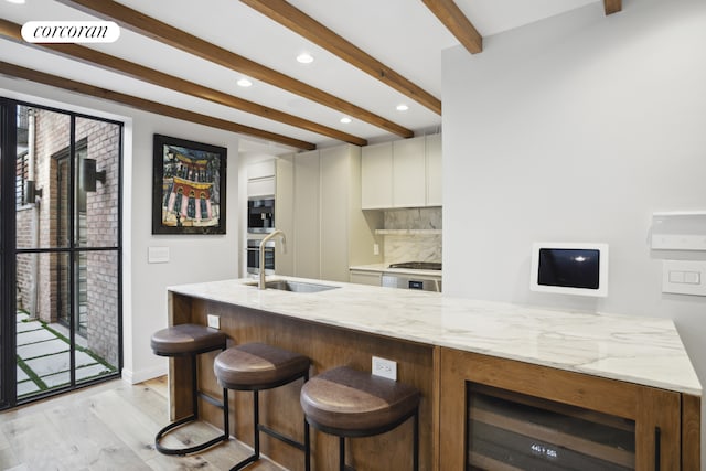 23 Bethune St Garden, Unit Garden, New York City, NY 10014 - bar featuring beam ceiling, wine cooler, decorative backsplash, light wood-style flooring, and recessed lighting
