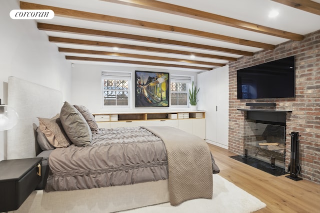 23 Bethune St Garden, Unit Garden, New York City, NY 10014 - bedroom with wood finished floors, beam ceiling, and a brick fireplace