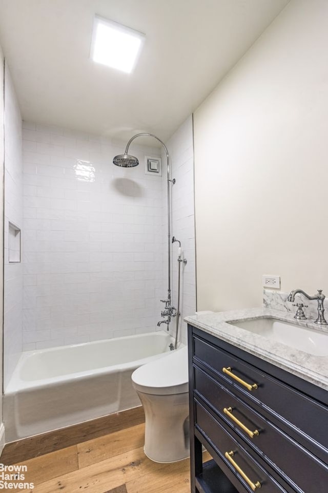 1001 5th Ave Unit 7A, New York City, NY 10028 - bathroom with vanity, wood finished floors, and bathtub / shower combination