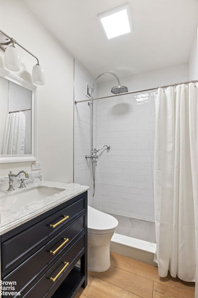 1001 5th Ave Unit 7A, New York City, NY 10028 - full bathroom with vanity, wood finished floors, and tiled shower