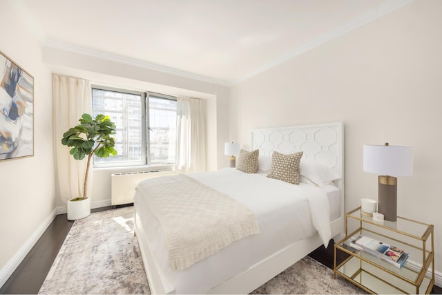 301 W 57th St Unit 16C, New York City, NY 10019 - bedroom featuring radiator, ornamental molding, and wood finished floors