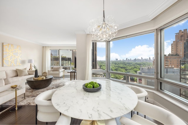 301 W 57th St Unit 16C, New York City, NY 10019 - dining room with ornamental molding, a skyline view, a chandelier, and wood finished floors