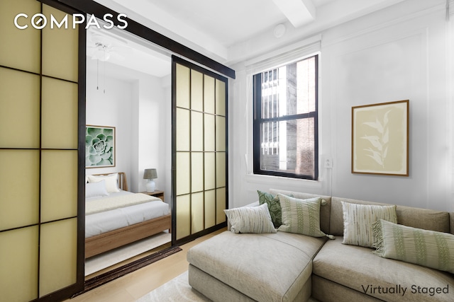 155 E 49th St Unit 3E, New York City, NY 10017 - bedroom featuring beam ceiling and wood finished floors