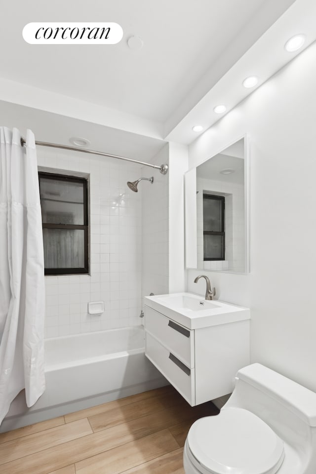56 Pine St Unit 4C, New York City, NY 10005 - full bath with shower / tub combo with curtain, vanity, wood finished floors, and recessed lighting