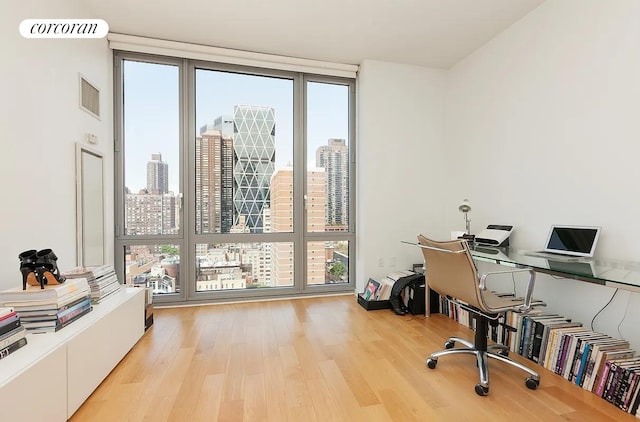310 W 52nd St Unit 18H, New York City, NY 10019 - office area with light wood-style flooring and floor to ceiling windows