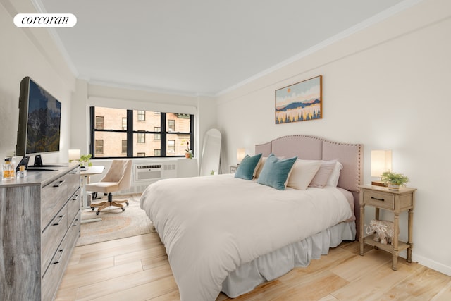 136 E 76th St Unit 10C, New York City, NY 10021 - bedroom featuring ornamental molding, light wood-style floors, a desk, and an AC wall unit