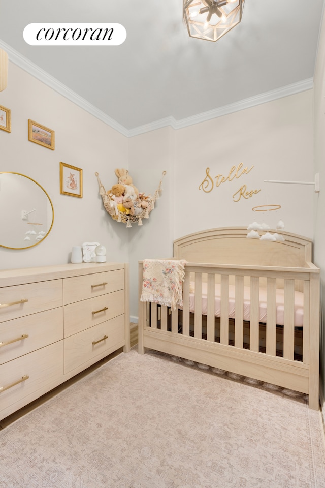 136 E 76th St Unit 10C, New York City, NY 10021 - bedroom featuring ornamental molding and a nursery area