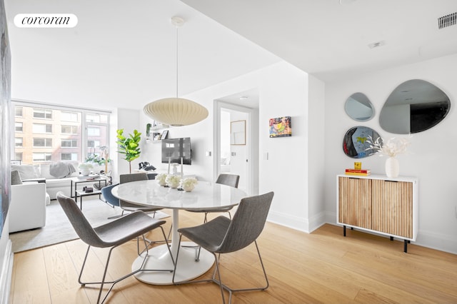 210 Warren St Unit 7F, New York City, NY 10282 - dining area with light wood-type flooring and baseboards