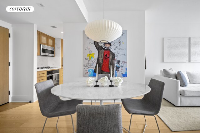 210 Warren St Unit 7F, New York City, NY 10282 - dining area with light wood finished floors and recessed lighting
