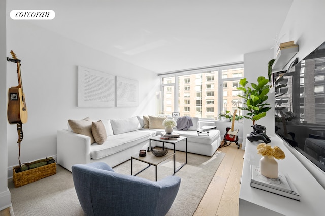 210 Warren St Unit 7F, New York City, NY 10282 - living room featuring light wood-style floors