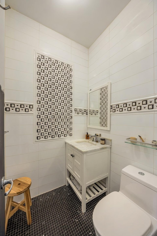 127 Cooper St, New York City, NY 11207 - bathroom with tile walls, vanity, and tile patterned floors