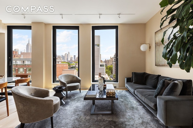 505 W 19th St Unit 7B, New York City, NY 10011 - living room featuring rail lighting and a skyline view