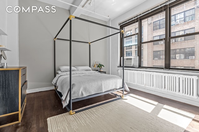 335 W 38th St Unit 6, New York City, NY 10018 - bedroom featuring hardwood / wood-style flooring, cooling unit, and radiator heating unit