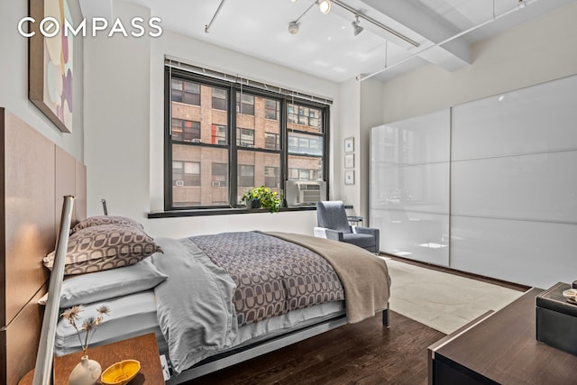 335 W 38th St Unit 6, New York City, NY 10018 - bedroom with wood finished floors, track lighting, and cooling unit