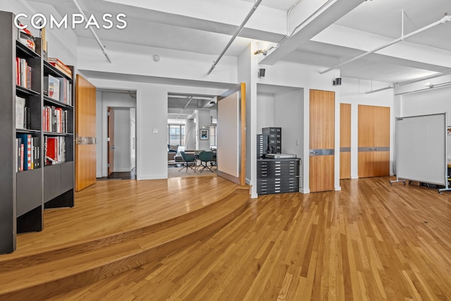 335 W 38th St Unit 6, New York City, NY 10018 - unfurnished living room with wood finished floors