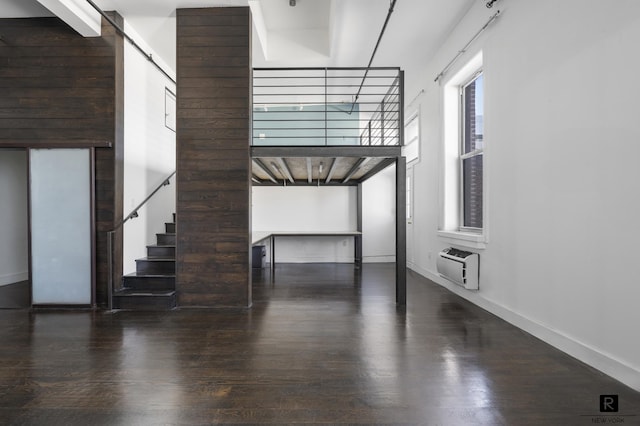 50 Bridge St Unit 506, New York City, NY 11201 - unfurnished living room with wood finished floors, stairs, and a wall mounted AC