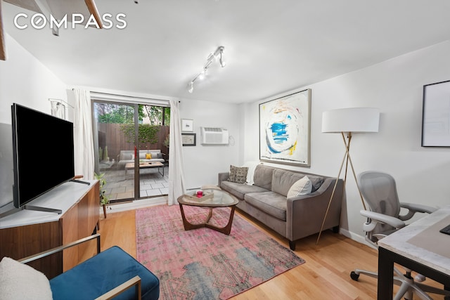 211 Thompson St Unit Gld, New York City, NY 10012 - living area featuring wood finished floors, a desk, track lighting, and a wall mounted AC
