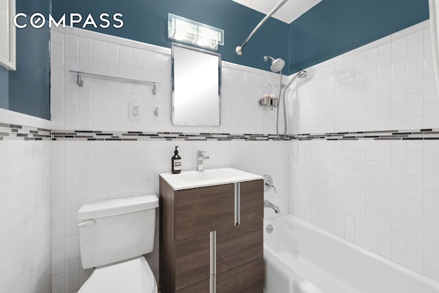 211 Thompson St Unit Gld, New York City, NY 10012 - bathroom featuring shower / bath combination, vanity, and tile walls
