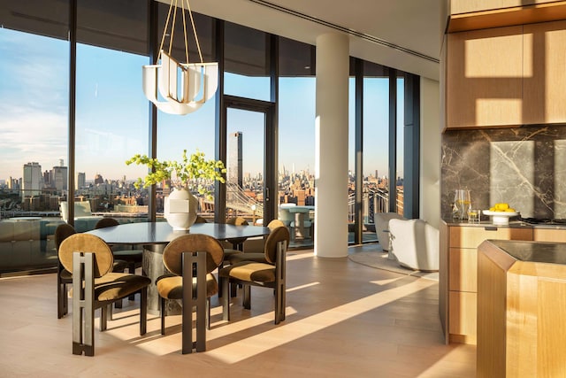 30 Front St Pha, Pha, New York City, NY 11201 - dining area featuring a view of skyline, a wall of windows, light wood-style flooring, and bar area