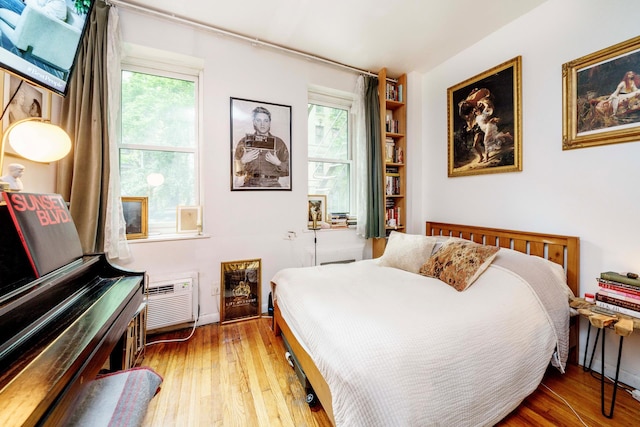 223 E 78th St Unit 2B, New York City, NY 10075 - bedroom with light wood finished floors and a wall unit AC