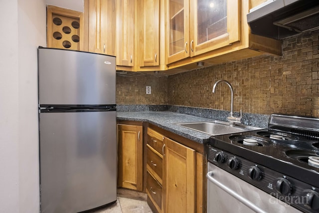 225 E 36th St Unit 1-A, New York City, NY 10016 - kitchen featuring stainless steel appliances, extractor fan, dark countertops, and tasteful backsplash