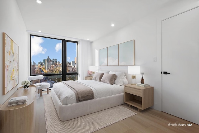27-23 Crescent St Unit 4-A, New York City, NY 11102 - bedroom featuring light wood-style floors, a skyline view, floor to ceiling windows, and recessed lighting