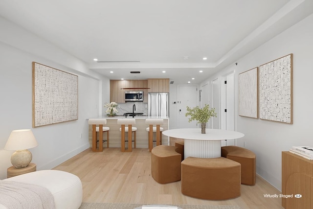 27-23 Crescent St Unit 4-A, New York City, NY 11102 - bathroom featuring wood finished floors, recessed lighting, and tasteful backsplash