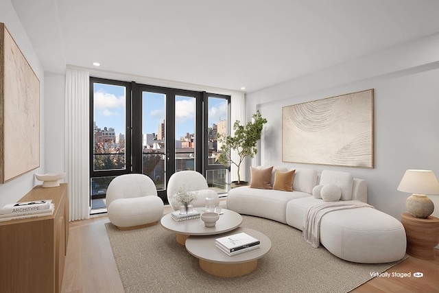 27-23 Crescent St Unit 4-A, New York City, NY 11102 - living room featuring wood finished floors, a skyline view, and recessed lighting