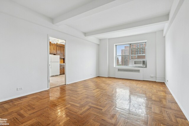 500 Grand St Unit C12A, New York City, NY 10002 - unfurnished room with radiator heating unit, beamed ceiling, and cooling unit