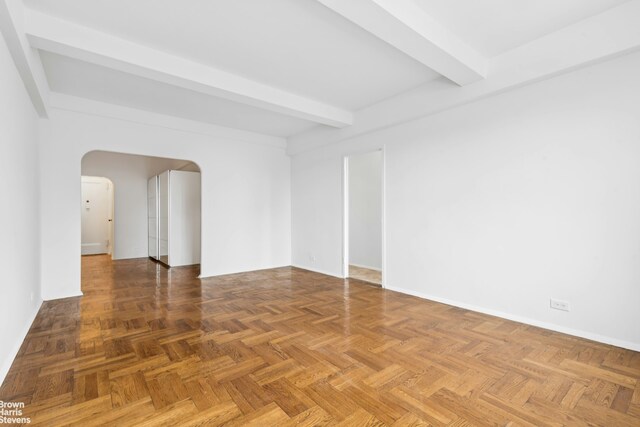 500 Grand St Unit C12A, New York City, NY 10002 - unfurnished room featuring arched walkways and beam ceiling