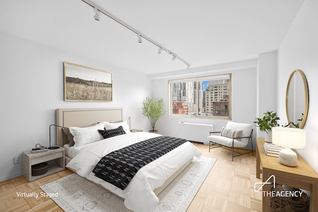 401 E 86th St Unit 8A, New York City, NY 10028 - bedroom featuring track lighting and radiator
