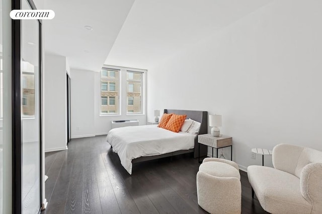 252 7th Ave Unit 10O, New York City, NY 10001 - bedroom featuring dark wood-style floors and a wall unit AC