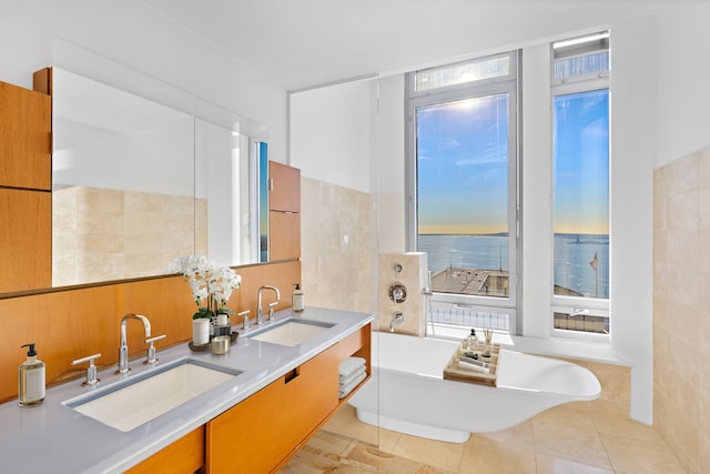 2 River Ter Unit Rh-8, New York City, NY 10282 - full bath with a freestanding tub, double vanity, tile walls, and tile patterned flooring