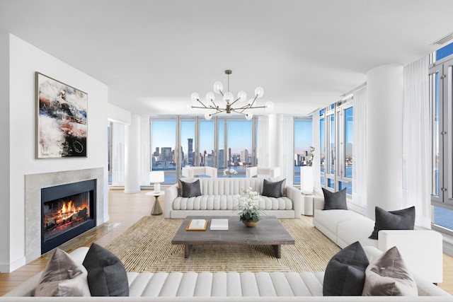 2 River Ter Unit Rh-8, New York City, NY 10282 - living area with a chandelier, wood finished floors, a fireplace with flush hearth, and a view of skyline