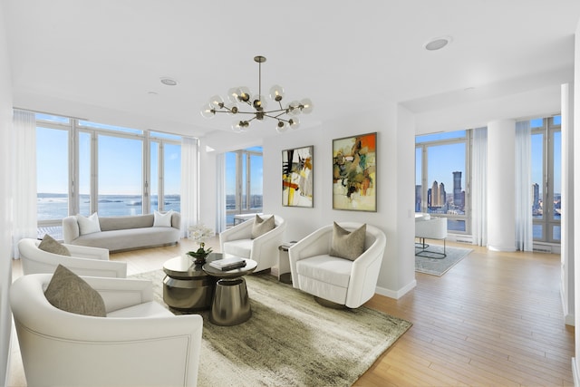 2 River Ter Unit Rh-8, New York City, NY 10282 - living area with healthy amount of natural light, a chandelier, hardwood / wood-style flooring, and a water view