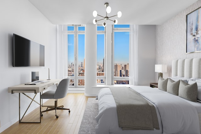 2 River Ter Unit Rh-8, New York City, NY 10282 - bedroom featuring a chandelier, wallpapered walls, wood finished floors, a desk, and a skyline view