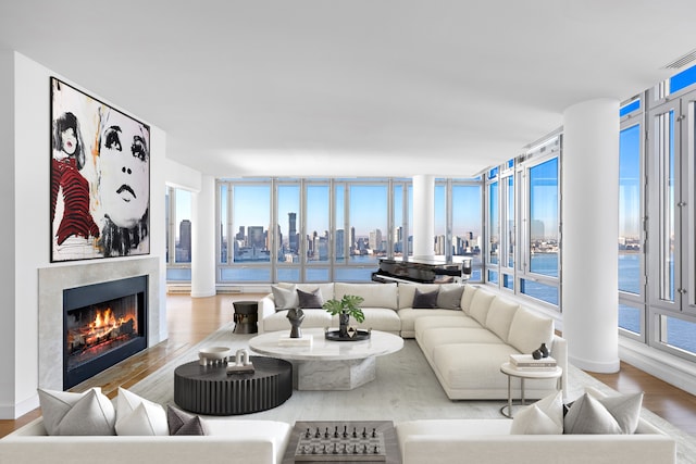 2 River Ter Unit Rh-8, New York City, NY 10282 - living area featuring wood finished floors, a tile fireplace, plenty of natural light, and a skyline view