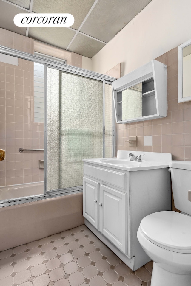 845 Bay Ridge Ave, New York City, NY 11220 - bathroom featuring vanity, shower / bath combination with glass door, tile walls, and tile patterned floors
