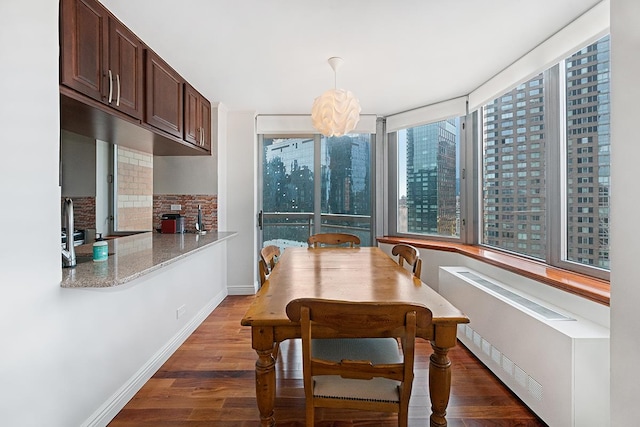 500 W 43rd St Unit 21-B, New York City, NY 10036 - dining room with radiator heating unit and wood finished floors
