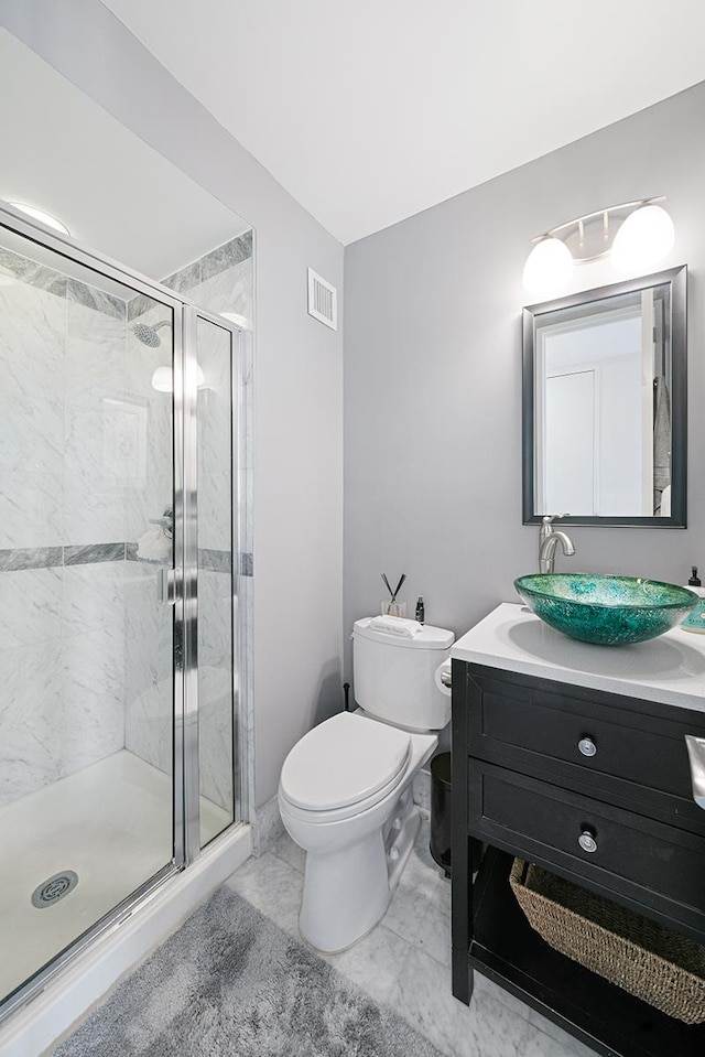 500 W 43rd St Unit 21-B, New York City, NY 10036 - bathroom with vanity, a stall shower, and marble look tile flooring