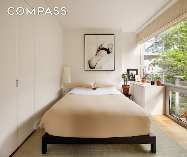425 E 13th St Unit 3F, New York City, NY 10009 - bedroom featuring multiple windows and wood finished floors